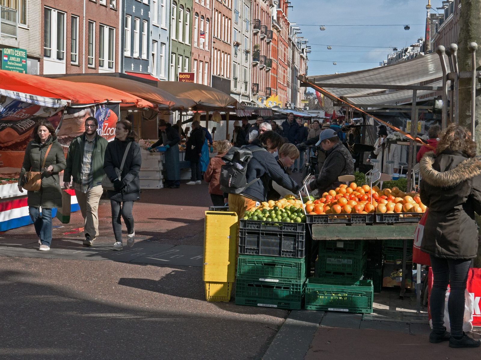 Fruit stall and shoppers at Albert Cuyp Market in De Pijp, one of the best free things to do in Amsterdam